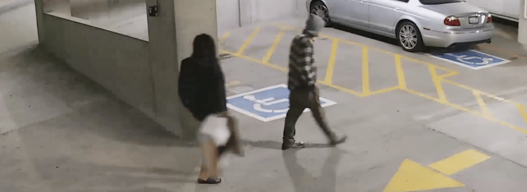 Two people tailgating into an apartment parking garage