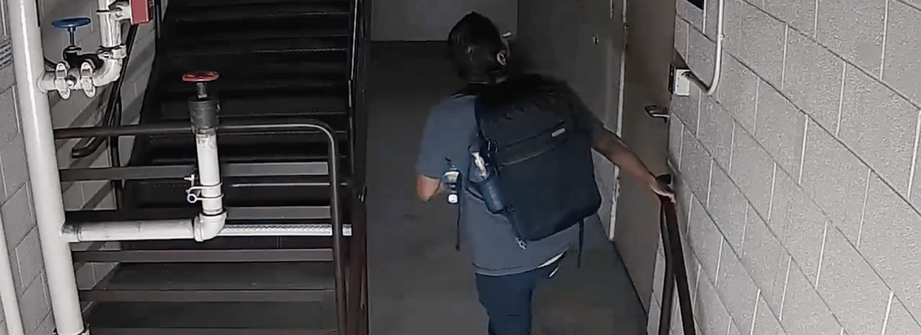 Person with backpack in office parking garage