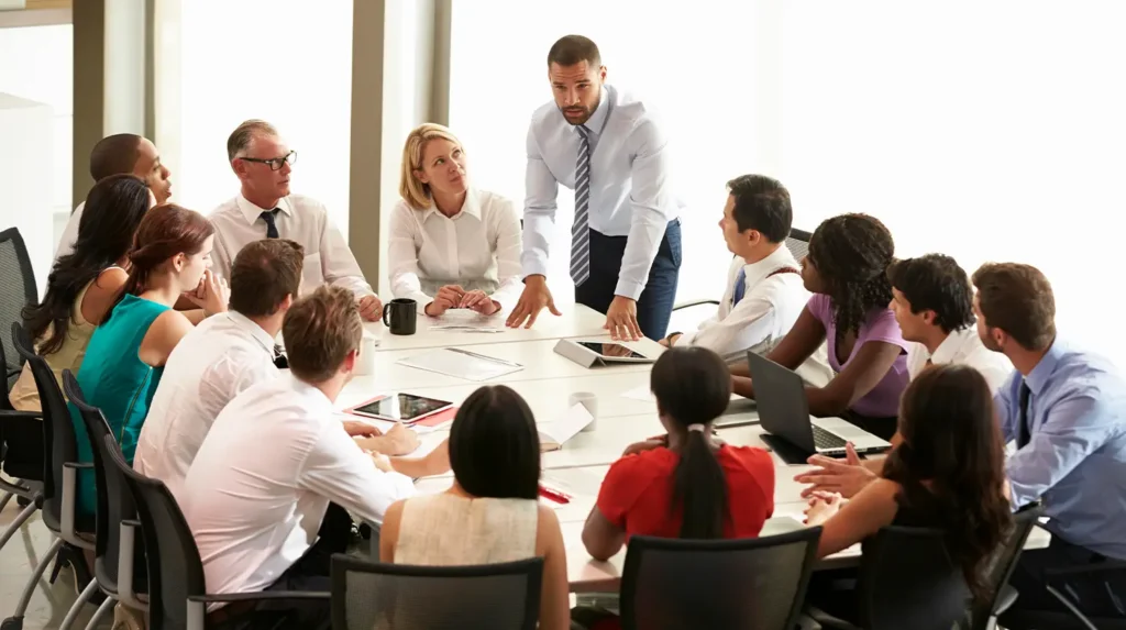 Group of people sitting around a table in a meeting