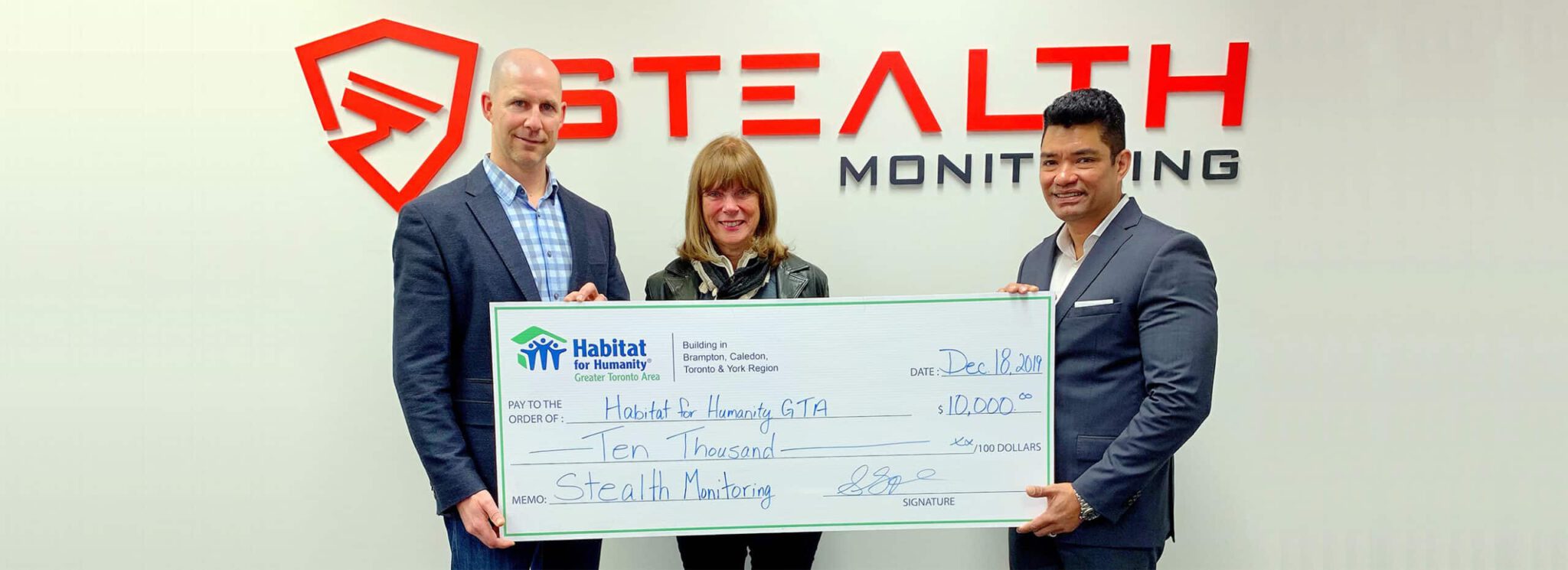 Stealth Monitoring Presents Check to Habitat for Humanity hero scaled 1