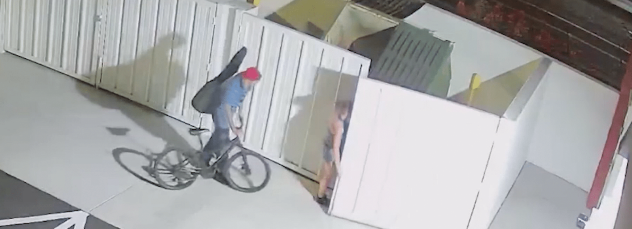 Three People Loitering by Dumpsters Behind Shopping Center Hero