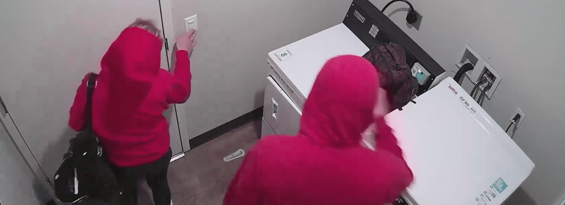 Two People Caught Tampering with Camera in Apartment Laundry Room Hero