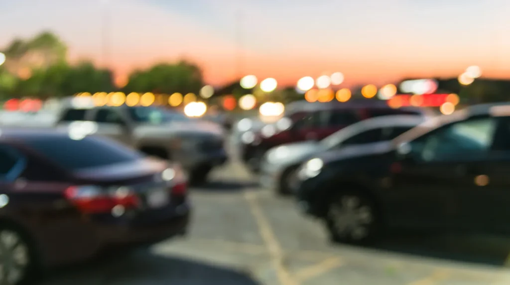 Blurred image of cars parked in a parking lot